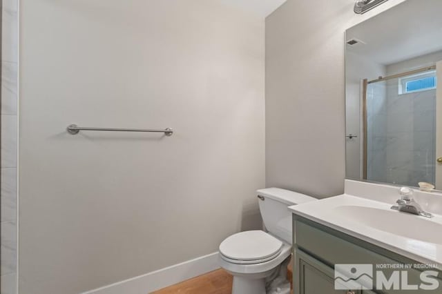 609 Caughlin, Reno, NV 89519 - full bath featuring toilet, vanity, baseboards, wood finished floors, and a shower