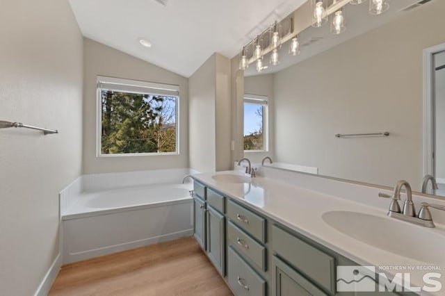 609 Caughlin, Reno, NV 89519 - full bath featuring plenty of natural light, wood finished floors, a bath, lofted ceiling, and double vanity