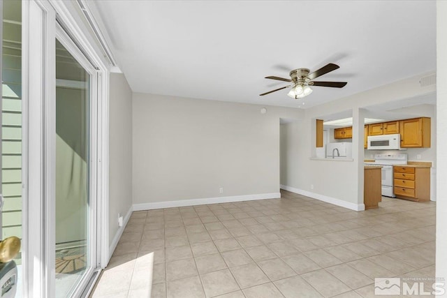 530 E Patriot Blvd, Reno, NV 89511 - unfurnished living room with ceiling fan, light tile patterned floors, baseboards, and a sink