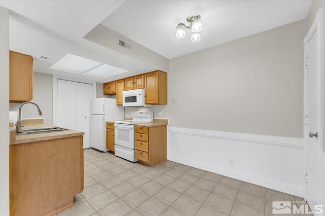 530 E Patriot Blvd, Reno, NV 89511 - kitchen featuring white appliances, a sink, light countertops, and light tile patterned flooring
