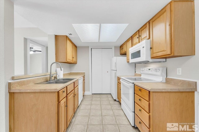 530 E Patriot Blvd, Reno, NV 89511 - kitchen featuring white appliances, a sink, light countertops, light tile patterned floors, and a ceiling fan
