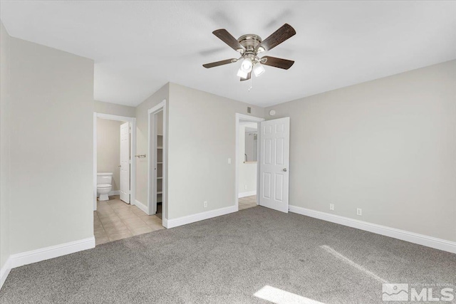 530 E Patriot Blvd, Reno, NV 89511 - unfurnished bedroom with carpet floors, baseboards, ensuite bathroom, and ceiling fan