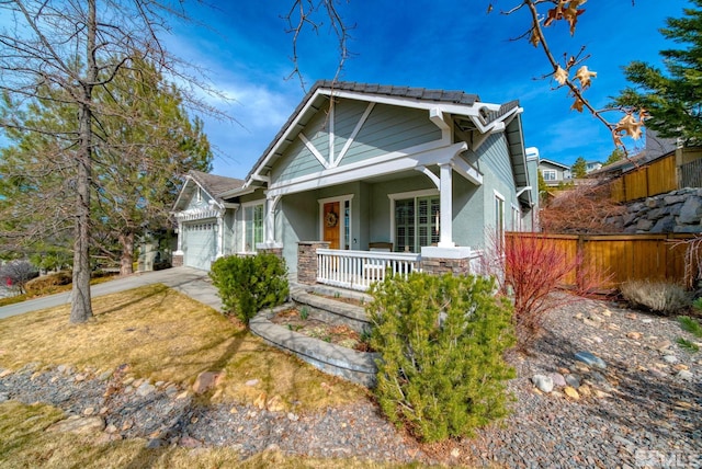 4940 Turning Leaf Way, Reno, NV 89519 - view of front of home with covered porch, a garage, stucco siding, concrete driveway, and stone siding