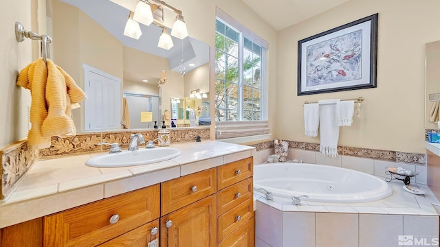 4940 Turning Leaf Way, Reno, NV 89519 - bathroom featuring a tub with jets, vanity, and a stall shower