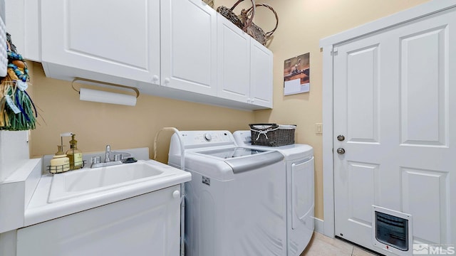 4940 Turning Leaf Way, Reno, NV 89519 - laundry room with cabinet space, washing machine and clothes dryer, heating unit, and light tile patterned flooring