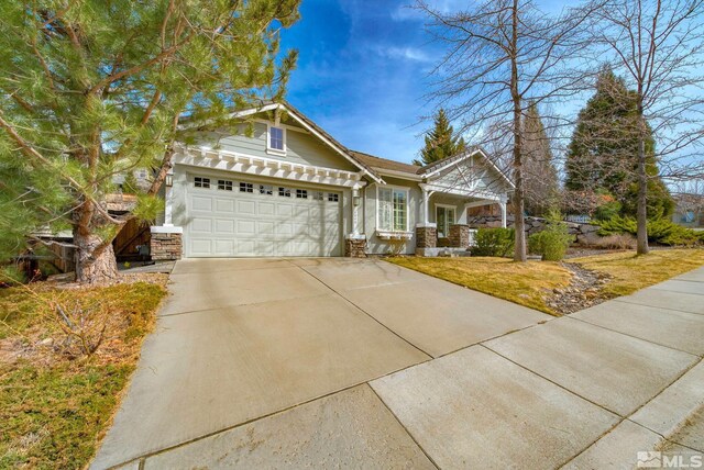4940 Turning Leaf Way, Reno, NV 89519 - craftsman-style house featuring a garage, concrete driveway, and stone siding