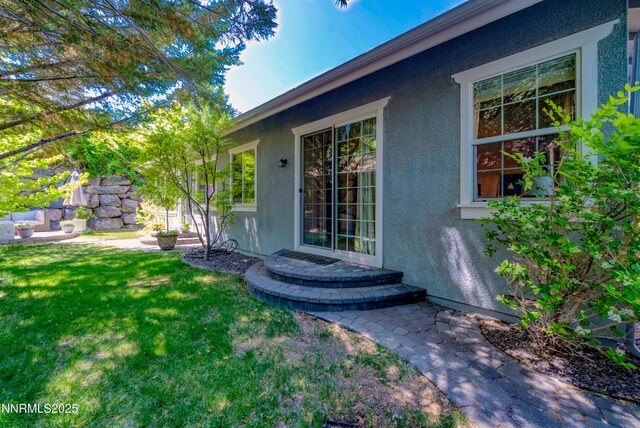 4940 Turning Leaf Way, Reno, NV 89519 - view of exterior entry with stucco siding and a lawn