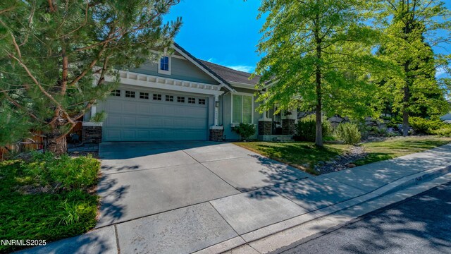 4940 Turning Leaf Way, Reno, NV 89519 - view of front of house featuring driveway, stone siding, and an attached garage