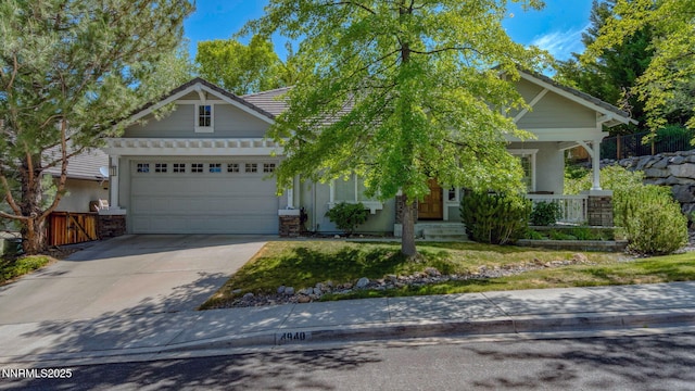 4940 Turning Leaf Way, Reno, NV 89519 - view of front of house featuring an attached garage, a porch, driveway, and a tile roof