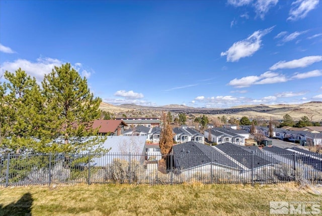 aerial view of residential area featuring mountains