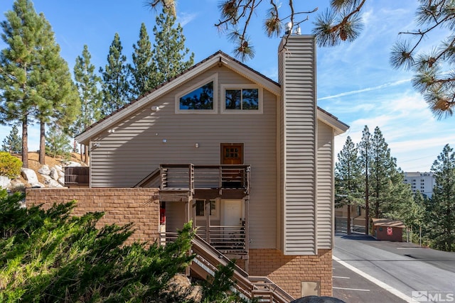 396 Tramway Dr # 3, Stateline, NV 89449 - view of front of house with a balcony, a chimney, and stairs