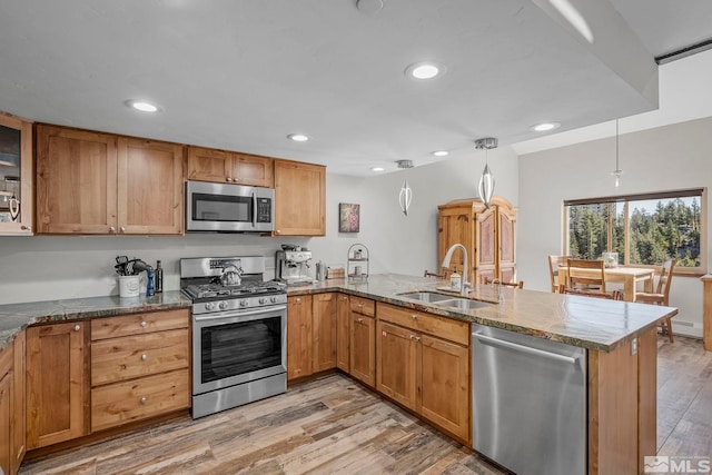 396 Tramway Dr # 3, Stateline, NV 89449 - kitchen with stainless steel appliances, a peninsula, a sink, recessed lighting, and light wood-type flooring