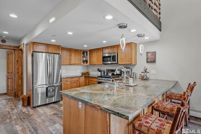 396 Tramway Dr # 3, Stateline, NV 89449 - kitchen with stainless steel appliances, a peninsula, glass insert cabinets, light wood-style floors, and recessed lighting
