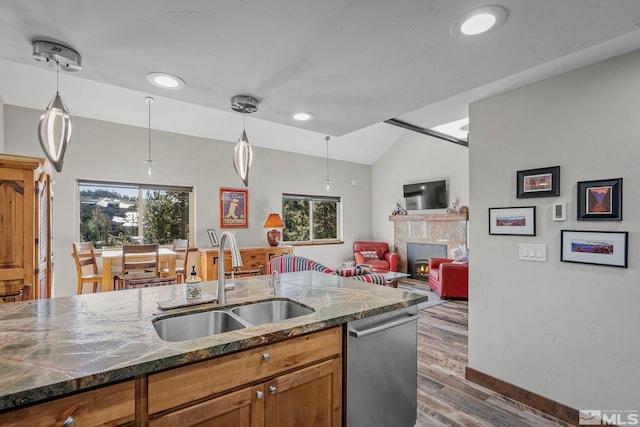 396 Tramway Dr # 3, Stateline, NV 89449 - kitchen featuring a sink, dishwasher, dark wood-style floors, a tiled fireplace, and plenty of natural light