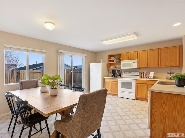 7433 Gannon Dr, Reno, NV 89506 - kitchen featuring white appliances, open shelves, light countertops, a sink, and light floors