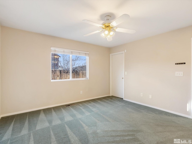7433 Gannon Dr, Reno, NV 89506 - unfurnished room with baseboards, dark carpet, and a ceiling fan