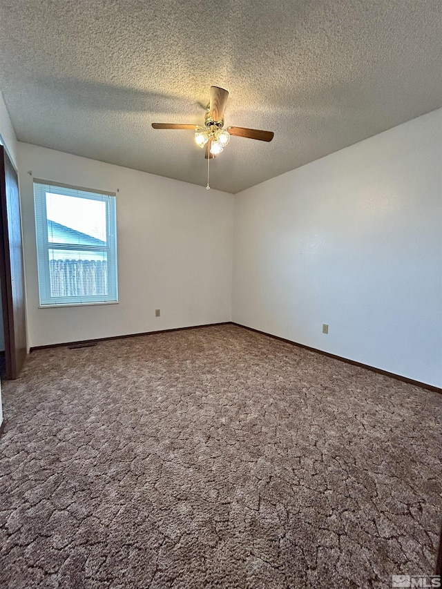 unfurnished room with a ceiling fan, a textured ceiling, carpet flooring, and baseboards