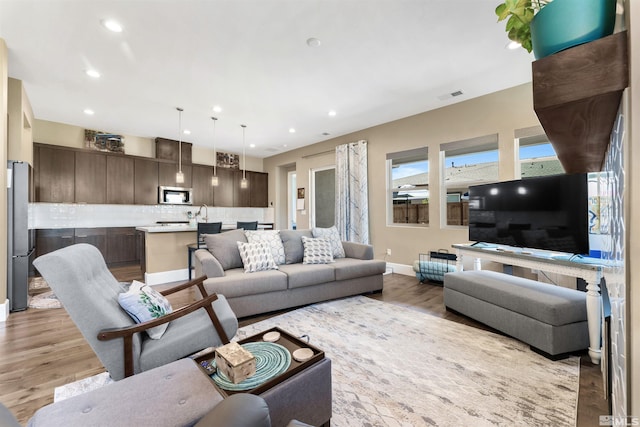 7317 Oakmont Ln, Sparks, NV 89436 - living room featuring light wood-type flooring, baseboards, and recessed lighting