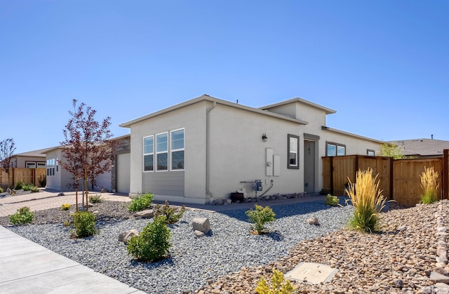 7317 Oakmont Ln, Sparks, NV 89436 - view of front of home featuring fence, an attached garage, and stucco siding