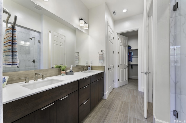7317 Oakmont Ln, Sparks, NV 89436 - full bathroom featuring a shower stall, double vanity, a spacious closet, baseboards, and recessed lighting