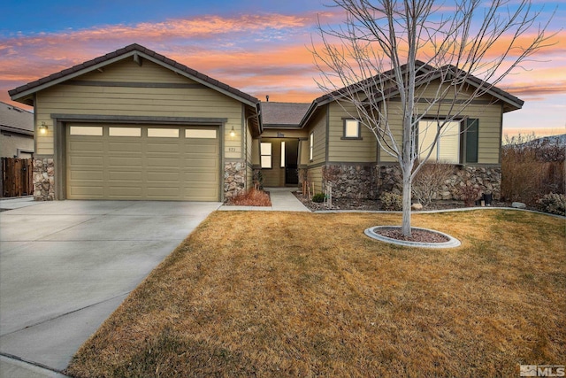 823 Gullane Ct, Dayton, NV 89403 - view of front of property with stone siding, driveway, and an attached garage