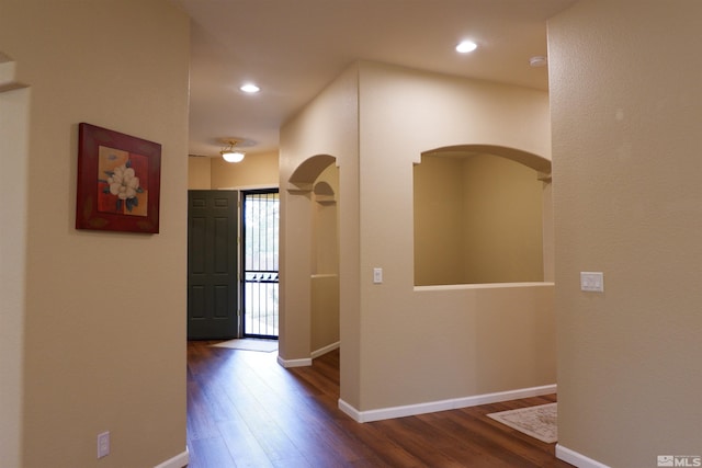 823 Gullane Ct, Dayton, NV 89403 - hallway with dark wood-style floors, arched walkways, baseboards, and recessed lighting