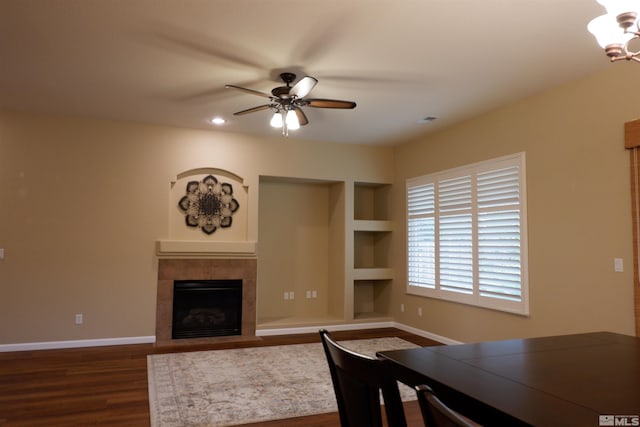 823 Gullane Ct, Dayton, NV 89403 - dining space with a tiled fireplace, a ceiling fan, dark wood finished floors, a chandelier, and baseboards