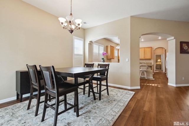 823 Gullane Ct, Dayton, NV 89403 - dining area featuring a chandelier, arched walkways, wood finished floors, and baseboards