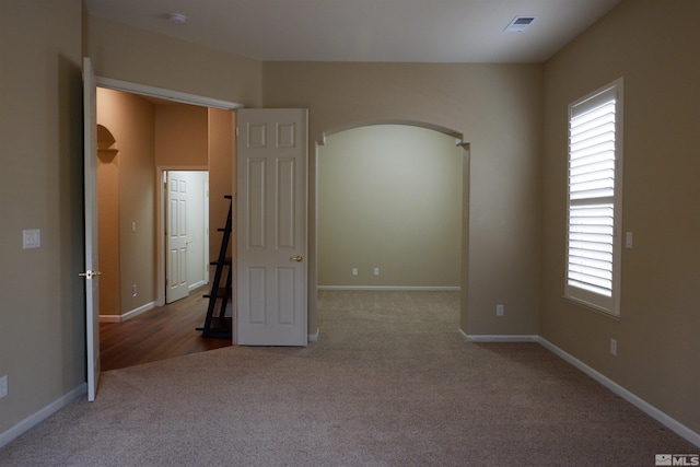 823 Gullane Ct, Dayton, NV 89403 - unfurnished bedroom with arched walkways, carpet flooring, multiple windows, and baseboards