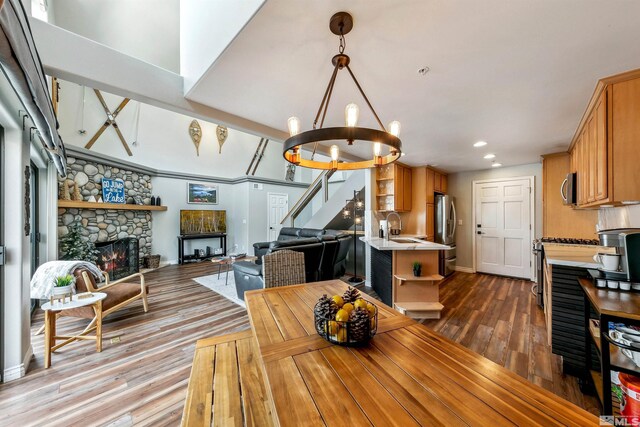400 Fairview Blvd Unit 217, Incline Village, NV 89451 - dining space with stairway, a chandelier, dark wood-style floors, recessed lighting, and a stone fireplace
