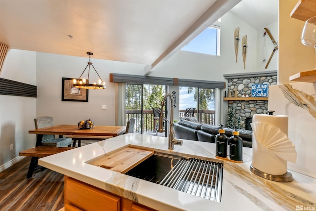 400 Fairview Blvd Unit 217, Incline Village, NV 89451 - kitchen featuring dark wood-style floors, a chandelier, a sink, baseboards, and pendant lighting