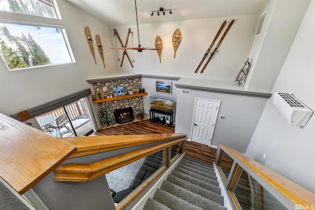 400 Fairview Blvd Unit 217, Incline Village, NV 89451 - stairway with rail lighting, a fireplace, and wood finished floors