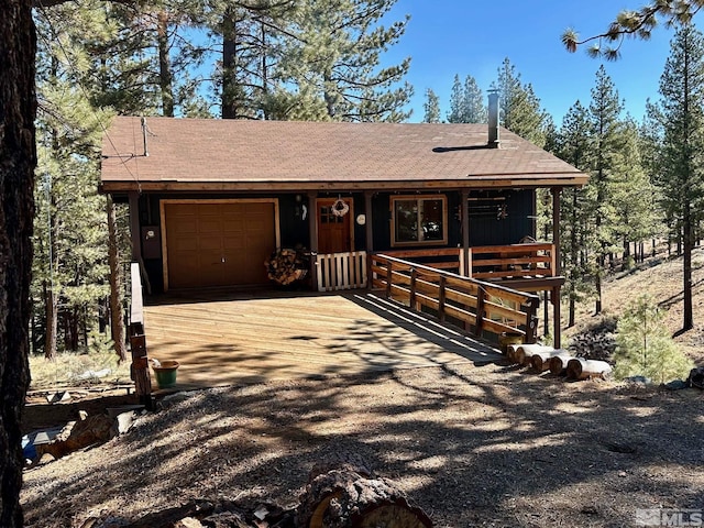 60 Lava Cap, Markleeville, CA 96120 - rustic home featuring an attached garage, covered porch, driveway, and roof with shingles