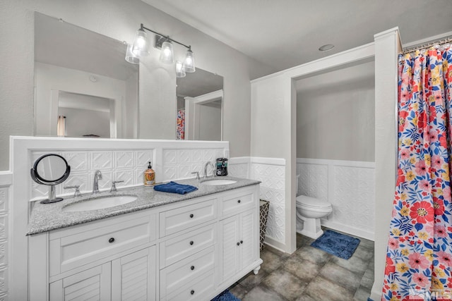 285 James Ave, Dayton, NV 89403 - bathroom featuring toilet, wainscoting, double vanity, and a shower with shower curtain