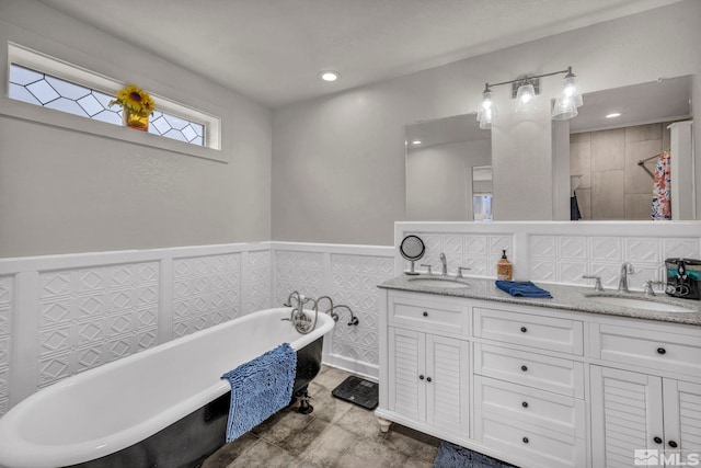 285 James Ave, Dayton, NV 89403 - full bathroom featuring double vanity, wainscoting, a freestanding tub, and recessed lighting