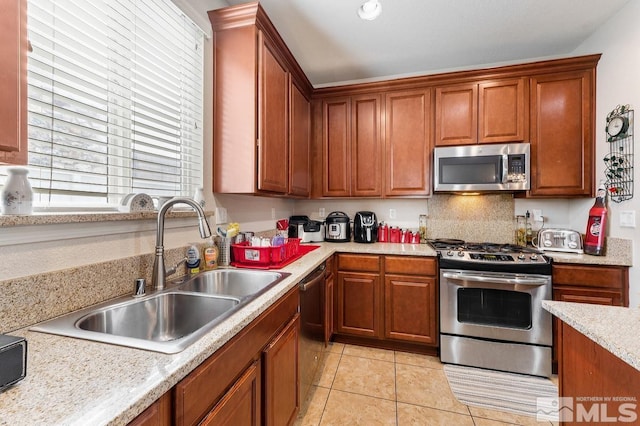 2020 Alamo Square Way, Reno, NV 89509 - kitchen with appliances with stainless steel finishes, a sink, light countertops, light tile patterned flooring, and brown cabinetry