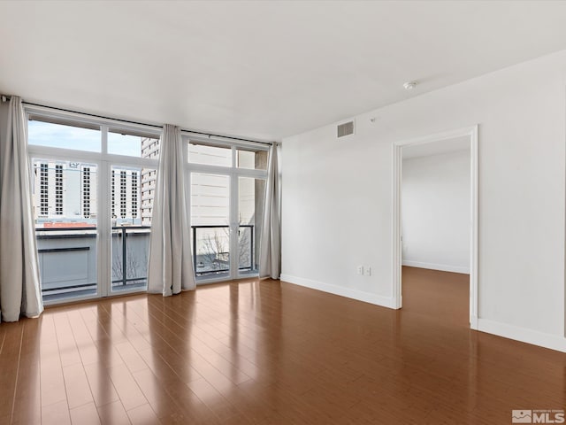 50 N Sierra Unit 605, Reno, NV 89501 - empty room with wood finished floors, baseboards, and a smoke detector