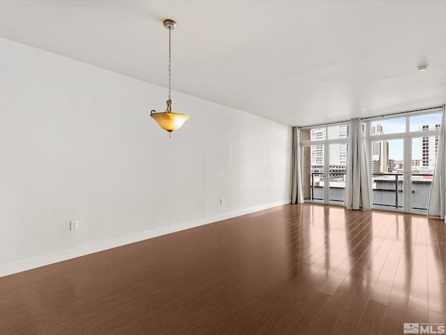 50 N Sierra Unit 605, Reno, NV 89501 - spare room featuring wood finished floors, baseboards, and expansive windows