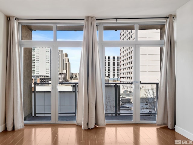 50 N Sierra Unit 605, Reno, NV 89501 - doorway to outside with a view of city, wood finished floors, and plenty of natural light