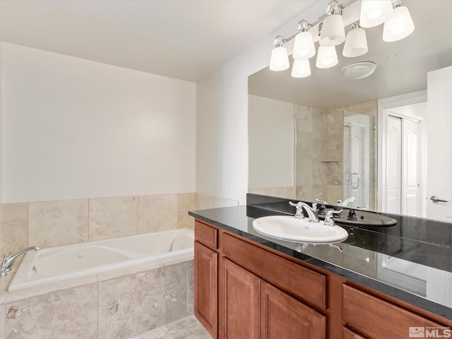 50 N Sierra Unit 605, Reno, NV 89501 - bathroom featuring a garden tub, vanity, and a stall shower
