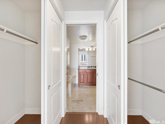 50 N Sierra Unit 605, Reno, NV 89501 - hallway featuring light wood-style flooring, a sink, and baseboards