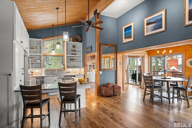 1005 Marlene St, Incline Village, NV 89451 - kitchen with ceiling fan, light stone counters, white cabinetry, wooden ceiling, and a peninsula