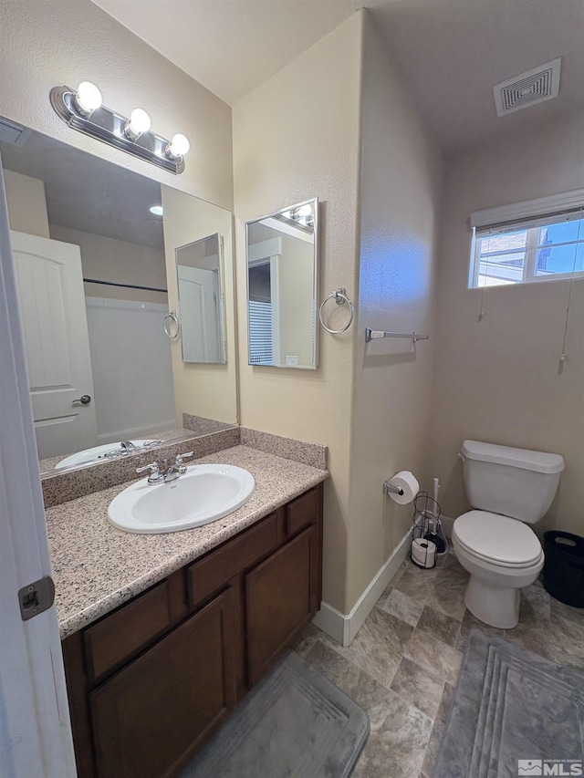 5282 Western Way, Winnemucca, NV 89445 - bathroom with toilet, vanity, and baseboards