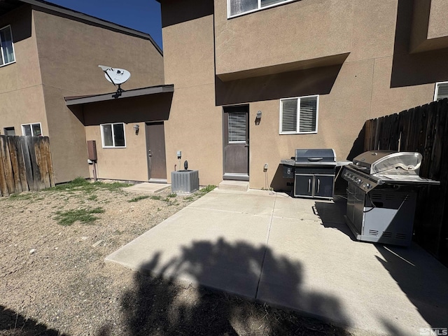 5282 Western Way, Winnemucca, NV 89445 - back of property with stucco siding, fence, central AC unit, and a patio area