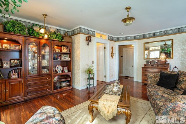 182 Mill St, Genoa, NV 89411 - living room with wood finished floors, crown molding, and wallpapered walls