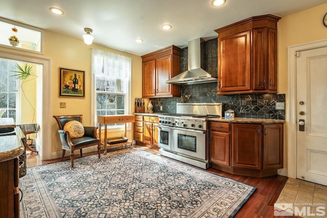 182 Mill St, Genoa, NV 89411 - kitchen featuring double oven range, wall chimney exhaust hood, tasteful backsplash, wood finished floors, and recessed lighting