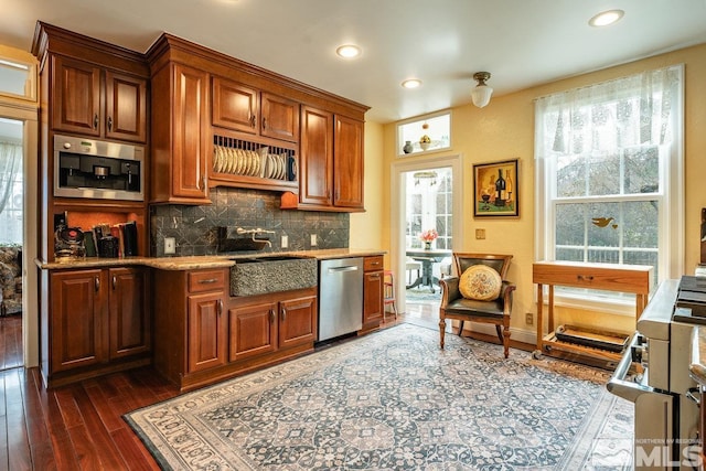 182 Mill St, Genoa, NV 89411 - kitchen with stainless steel dishwasher, dark wood-type flooring, recessed lighting, light stone counters, and tasteful backsplash