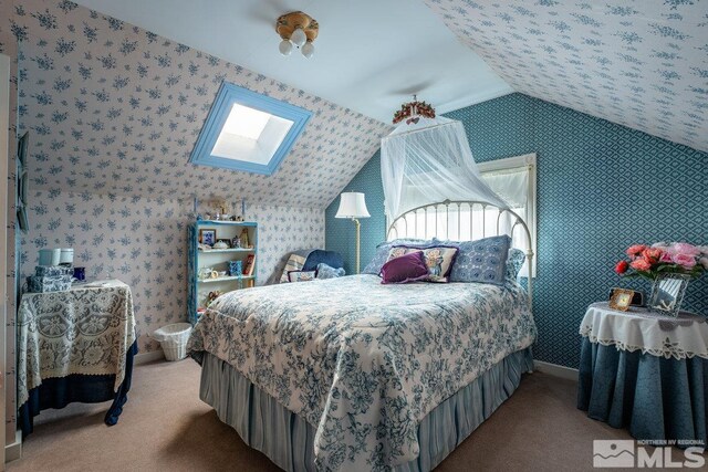 182 Mill St, Genoa, NV 89411 - carpeted bedroom with vaulted ceiling, a skylight, baseboards, and wallpapered walls
