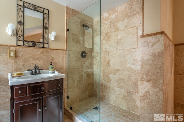 182 Mill St, Genoa, NV 89411 - bathroom with walk in shower, wainscoting, vanity, and tile walls