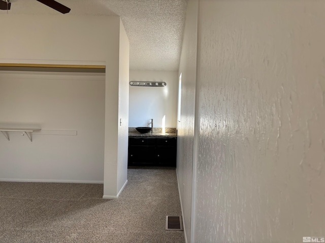 1721 Burnside Dr, Sparks, NV 89434 - hallway with carpet flooring, a sink, baseboards, and a textured ceiling